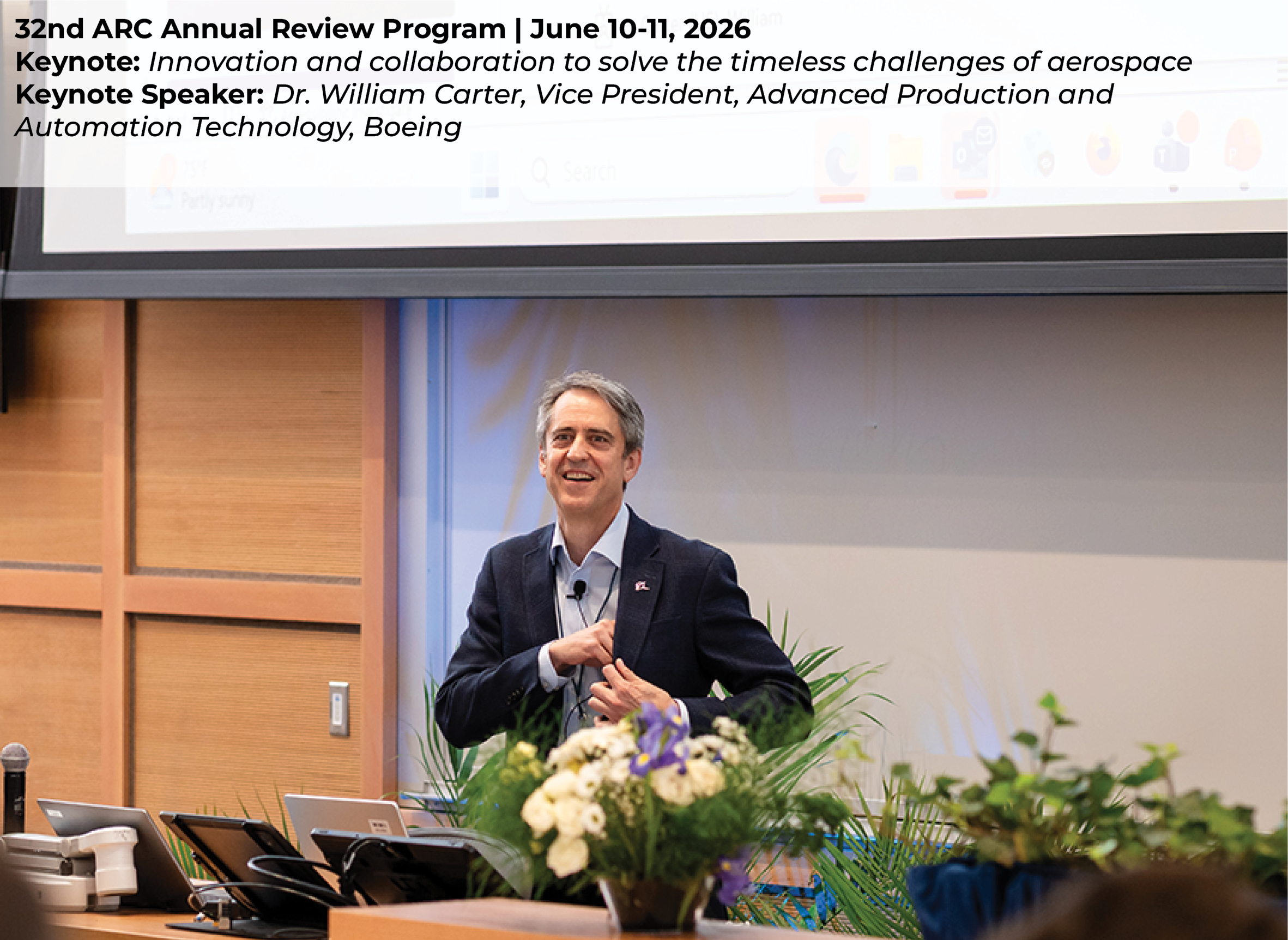 Dr. William Carter giving a keynote presentation at a podium in an auditorium, addressing a seated audience during a formal event.