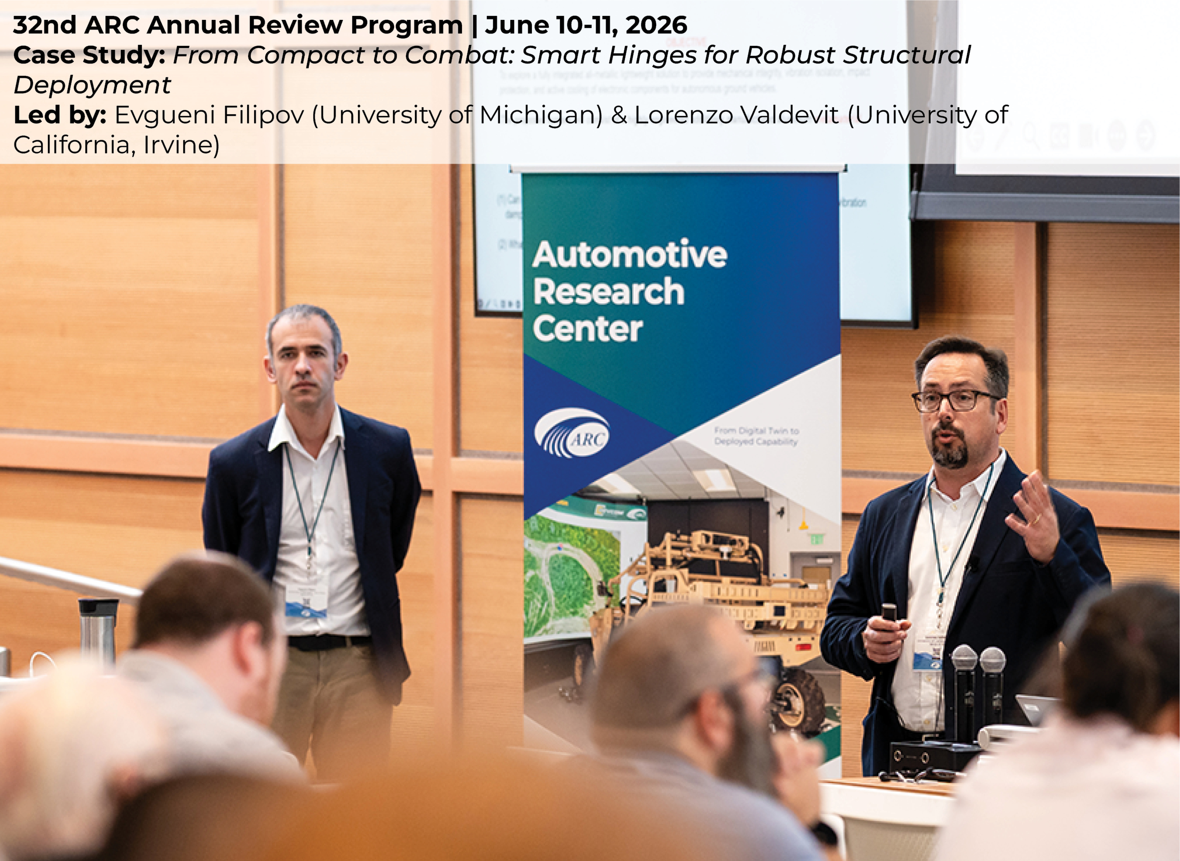 Evgueni Filipov & Lorenzo Valdevit giving a case study presentation in an auditorium, addressing a seated audience during a formal event.