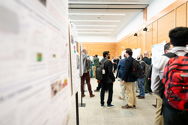 Faculty, students, Army scientists, and industry engineers engage with demonstrations and posters at the Automotive Research Center review.