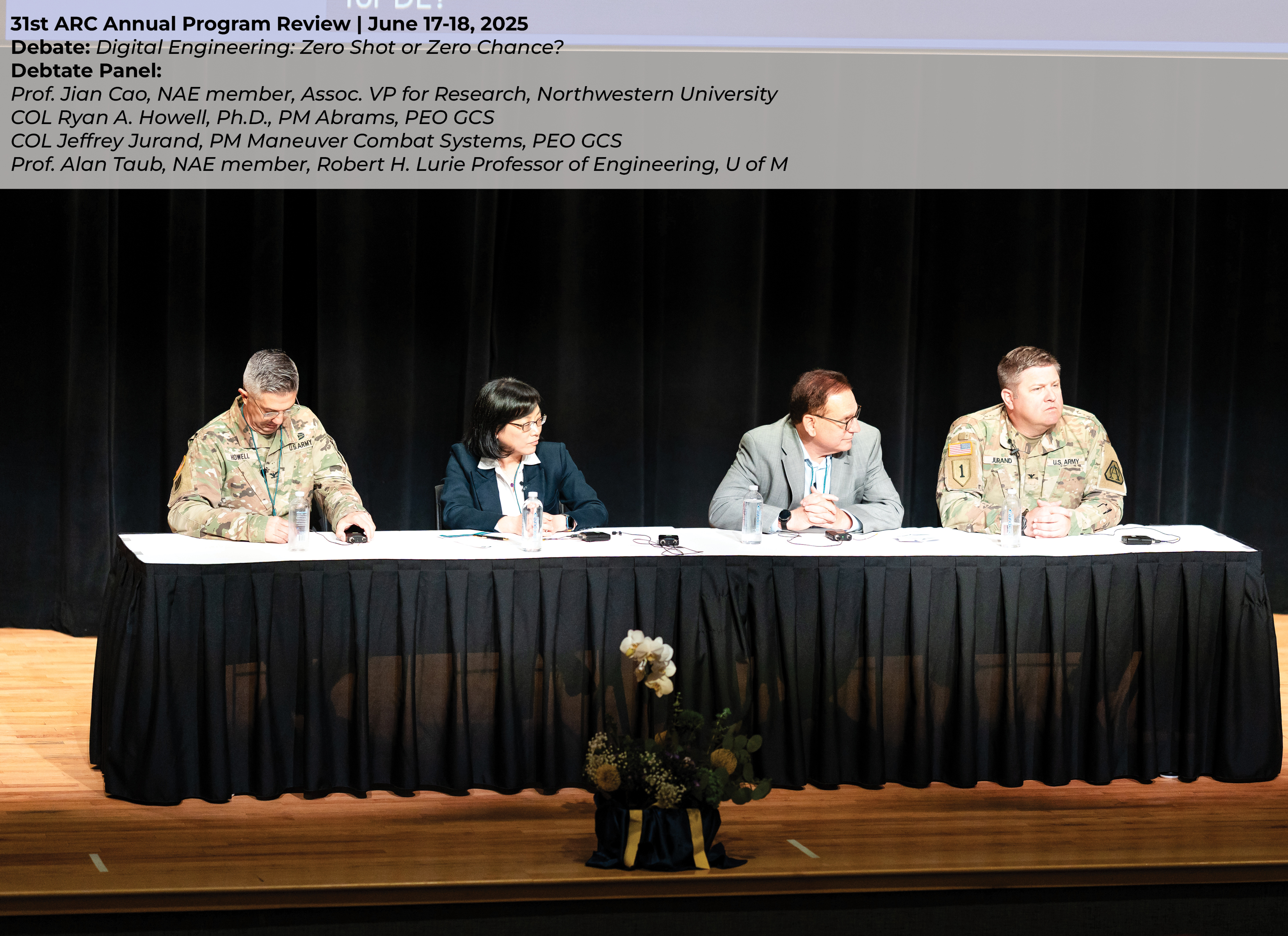4 panelists on stage during the 31st ARC Annual Review. Panelists are seated at a table in front of a black curtain on a stage. 