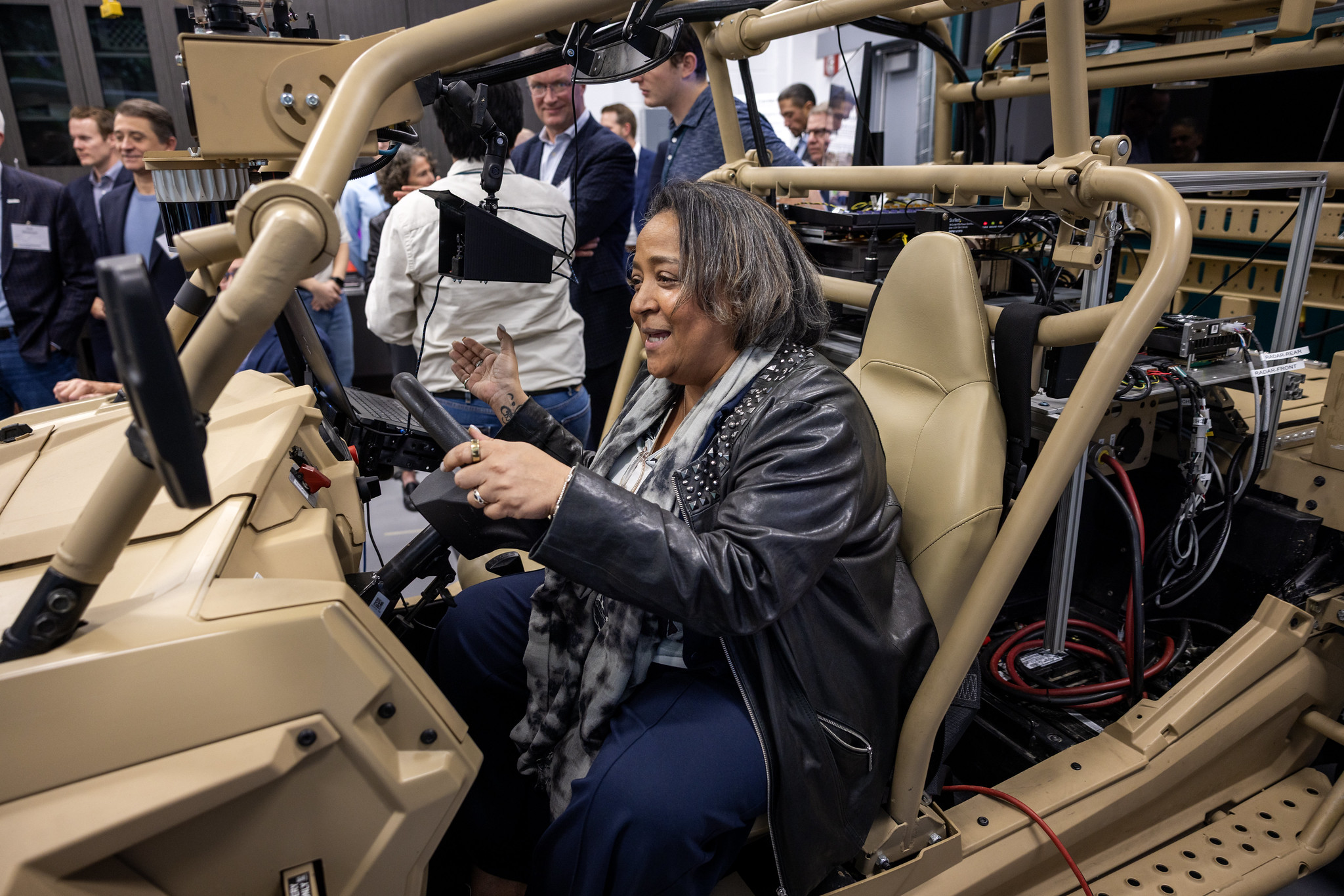 Crystal E. Ashby sitting in army vehicle with hands on the steering wheel during a live demonstration.