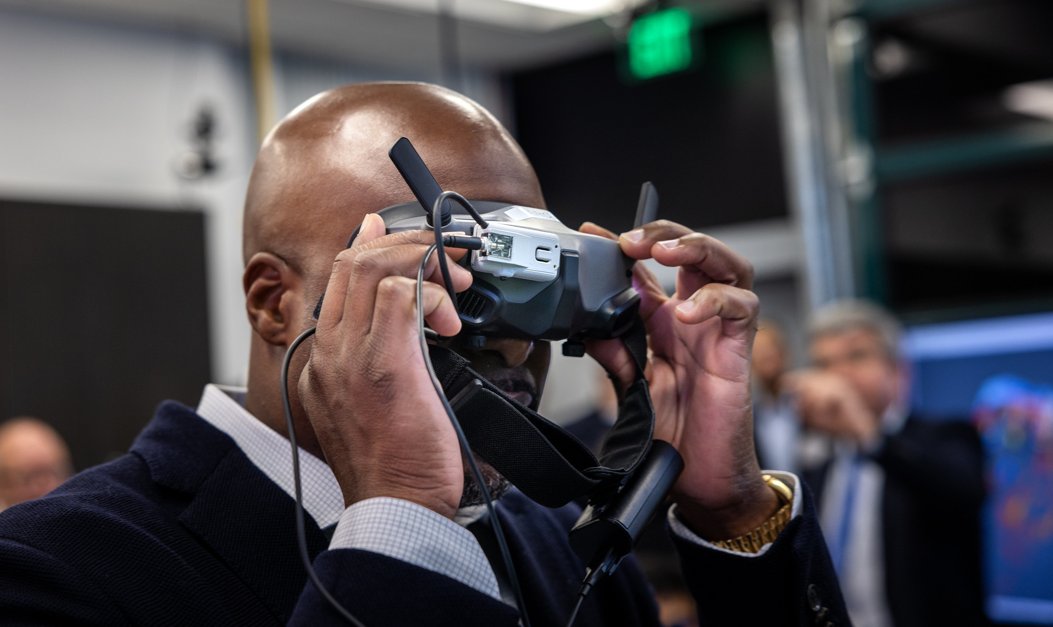 Larry Brinker Jr. wearing holding headset up to his eyes.