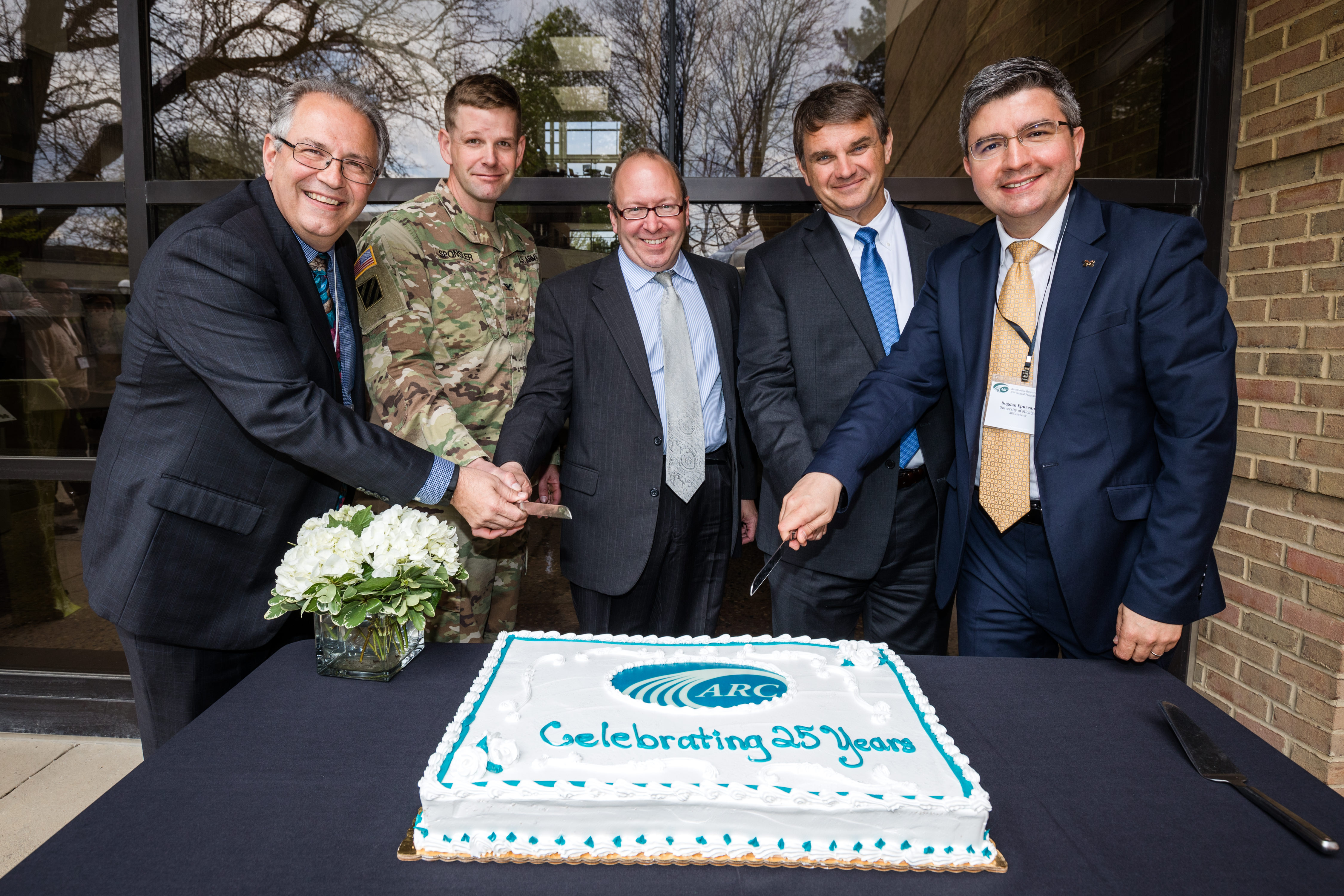 Boehman, Sponsler, Gorsich, Langhout and Epureanu cutting twenty-fifth anniversary cake